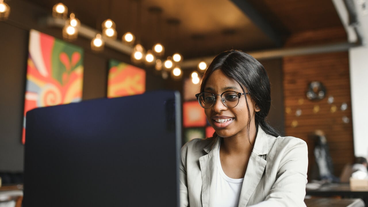 What’s new in super this financial year? A women in the office reading a news article about what's new in super this year