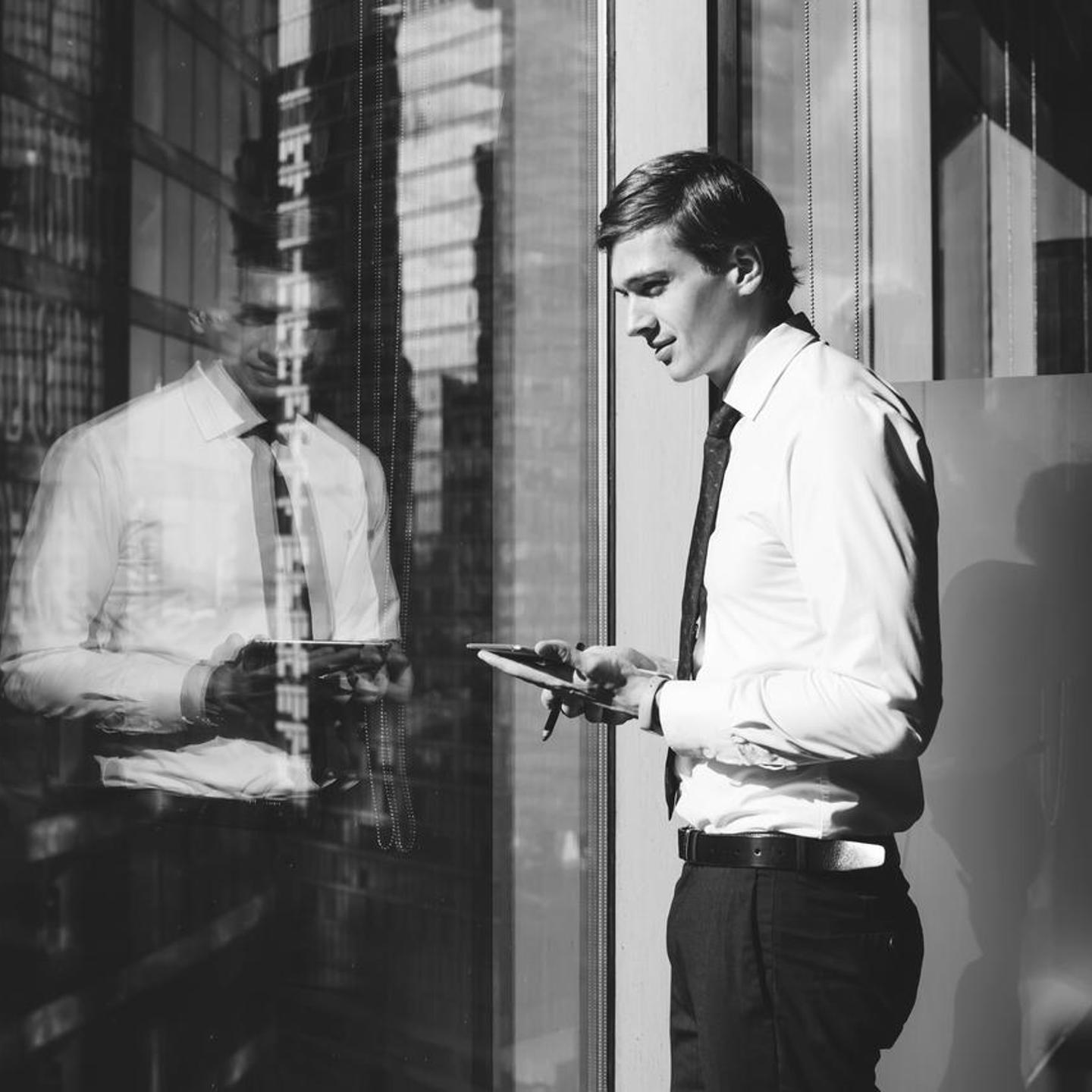 young-man-looking-out-office-tower.jpg