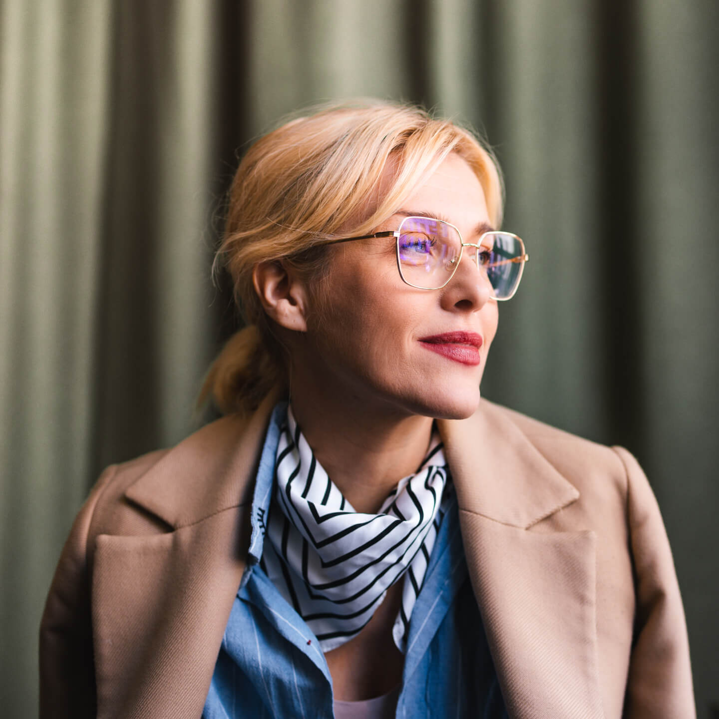 Businesswoman in office wearing coat